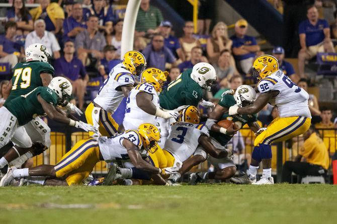 LSU sophomore safety JaCoby Stevens (3) and LSU sophomore defensive end Neil Farrell Jr. (92) tackle the runner during the Tigers&#8217; 31-0 victory over Southeastern on Saturday, Sept. 8, 2018, in Tiger Stadium.