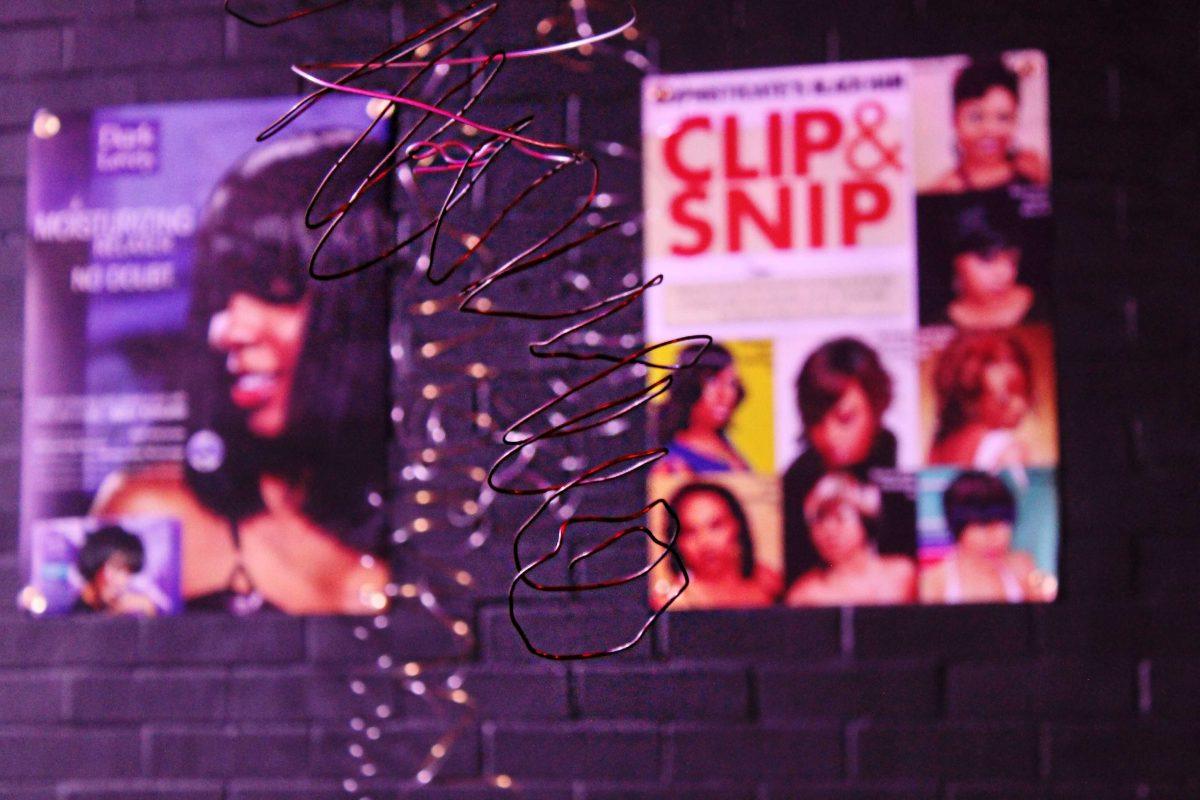 Wire hangs from the ceiling to represent curly hair for "NAPPY Hairstories" at Hopkins Black Box Theatre.