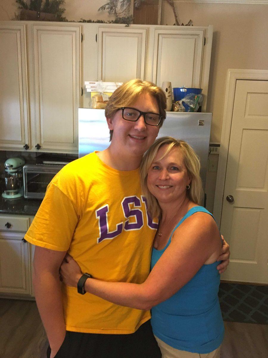 Max Gruver and his mother Rae Ann hug in a family friend's home.