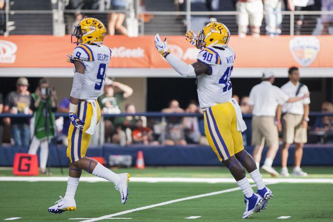 LSU junior linebacker Devin White (40) and sophomore safety Grant Delpit (9) celebrate during the Tigers' game against Miami in the AdvoCare Classic on Sunday, Sept. 2, 2018 at AT&amp;T Stadium in Arlington, Texas.