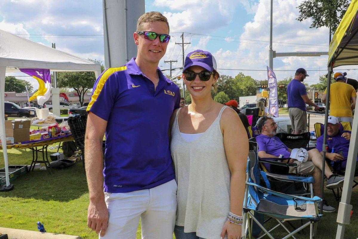 LSU fans Anna Crousillac and Mac McCoy tailgate outside AT&amp;T Stadium on Sunday, Sept. 2, 2018 in Arlington, Texas.