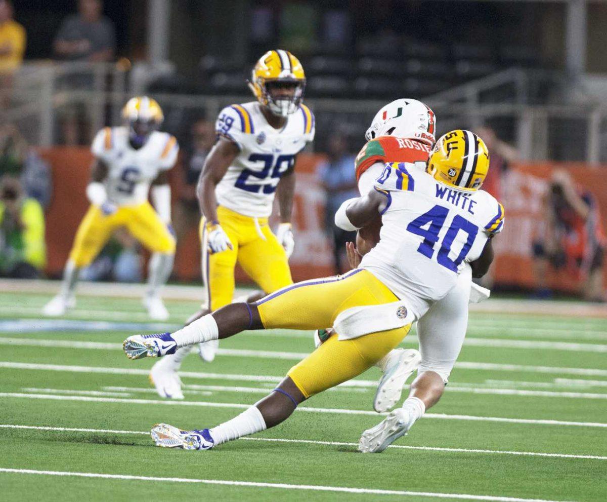 LSU junior linebacker Devin White (40) makes a tackle during the Tigers' game against Miami in the AdvoCare Classic on Sunday, Sept. 2, 2018 in AT&amp;T Stadium in Arlington, Texas.