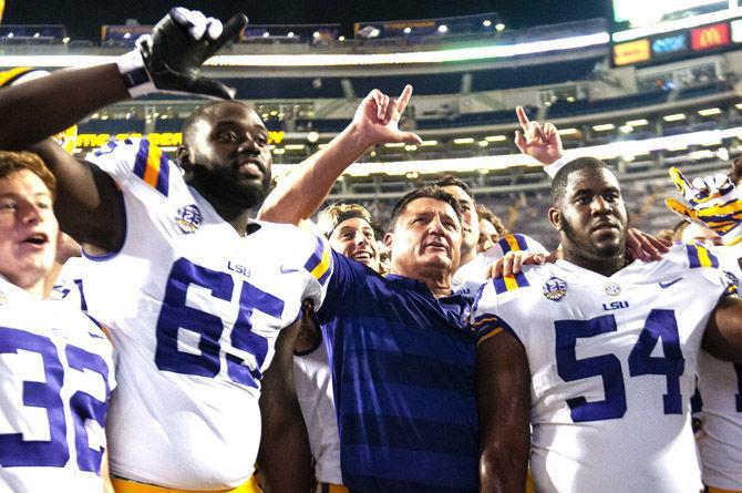 Head coach Ed Orgeron holds up an L alongside his players during the alma mater during the Tigers&#8217; 31-0 victory over Southeastern on Saturday, Sept. 8, 2018, in Tiger Stadium.