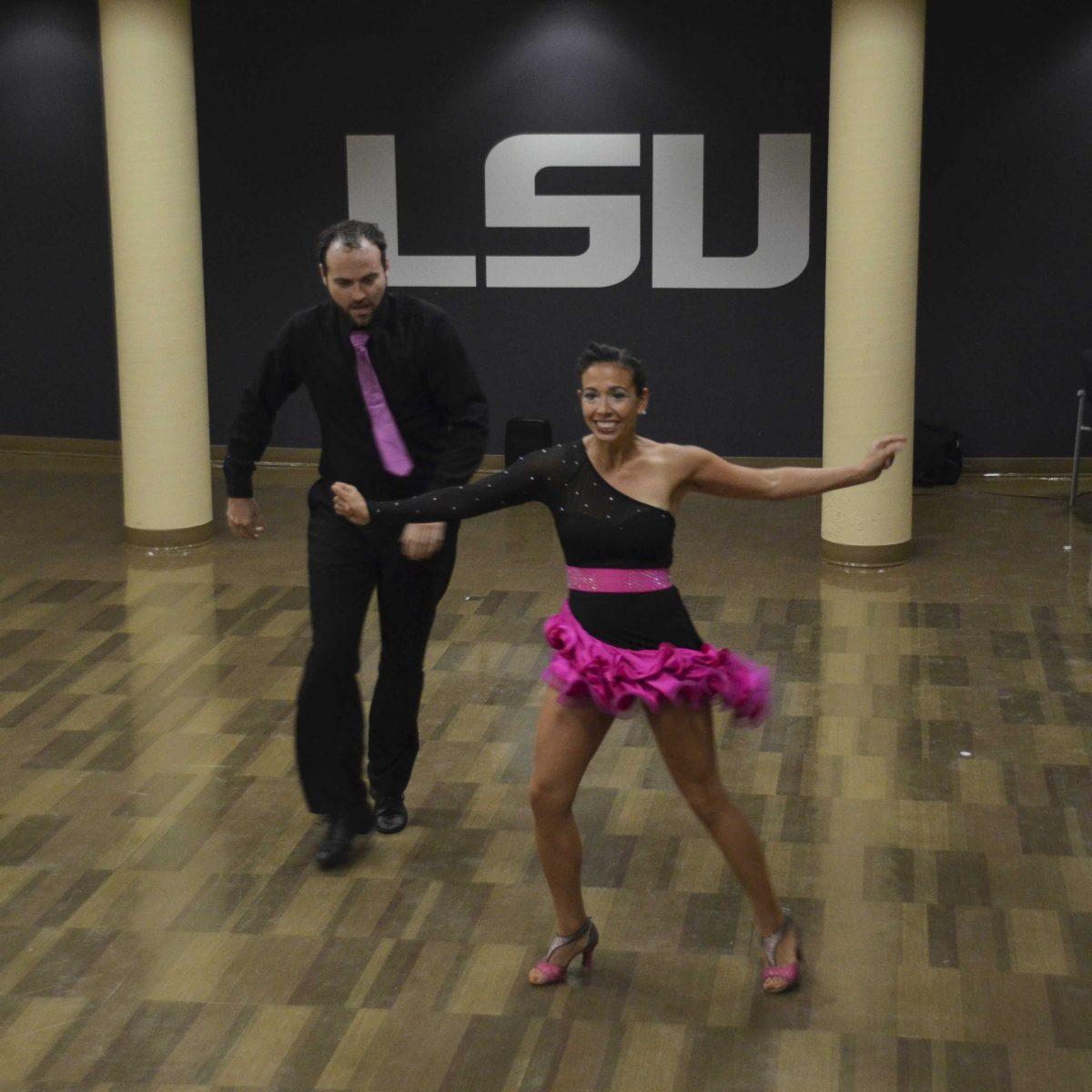 Director of Salsa Ardiente Dance Company Sarita Reyna and Jason Priddle showcase their salsa dancing during an event hosted by the Hispanic Student Cultural Society on Thursday, Sept. 28, 2017 in the Student Union theater reception room.