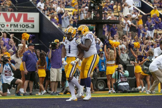 LSU freshman wide receiver Ja'Marr Chase (1) and LSU senior guard Garrett Brumfield (78) celebrate in the end zone during the Tigers&#8217; 31-0 victory over Southeastern in Tiger Stadium on Saturday, Sept. 8, 2018.