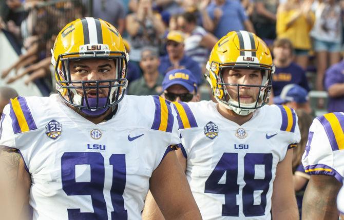 LSU junior defensive end Breiden Fehoko (91) and LSU junior deep snapper Blake Ferguson (48) lead the team on to the field during the Tigers&#8217; 31-0 victory over Southeastern on Saturday, Sept. 8, 2018, in Tiger Stadium.