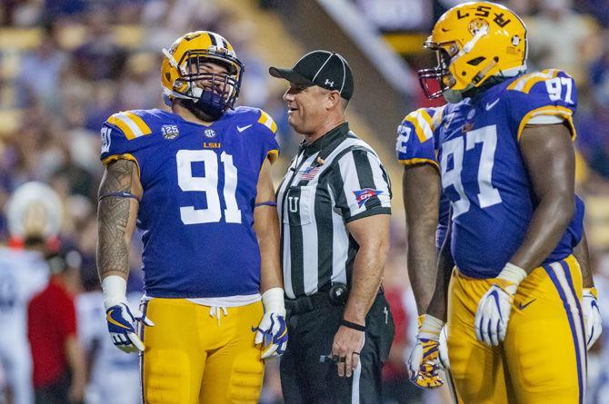 LSU junior defensive end Breiden Fehoko (91) talks with his teammate during the Tigers' 38-21 victory against LA Tech on Saturday, Sept. 22, 2018, in Tiger Stadium.