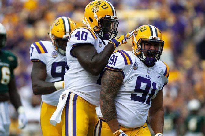 LSU junior linebacker Devin White (40) celebrates with LSU junior defensive end Breiden Fehoko (91) after a favorable play the field during the Tigers&#8217; 31-0 victory over Southeastern on Saturday, Sept. 8, 2018, in Tiger Stadium.