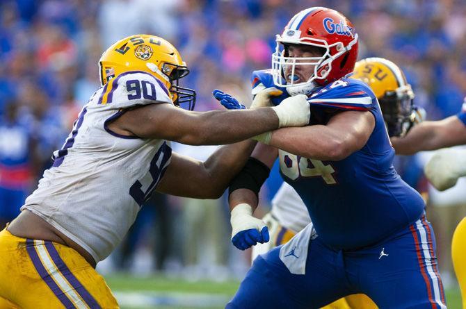 LSU junior defensive end Rashard Lawrence (90) makes a tackle during the Tigers&#8217; 27-19 loss against the University of Florida on Saturday, Sept. 2018 in Ben Hill Griffin Stadium.