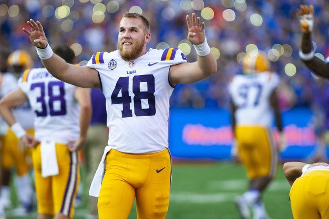 LSU junior long snapper Blake Ferguson (48) holds up a four for the fourth quarter during the Tigers&#8217; 27-19 loss against the University of Florida on Saturday, Sept. 2018 in Ben Hill Griffin Stadium.