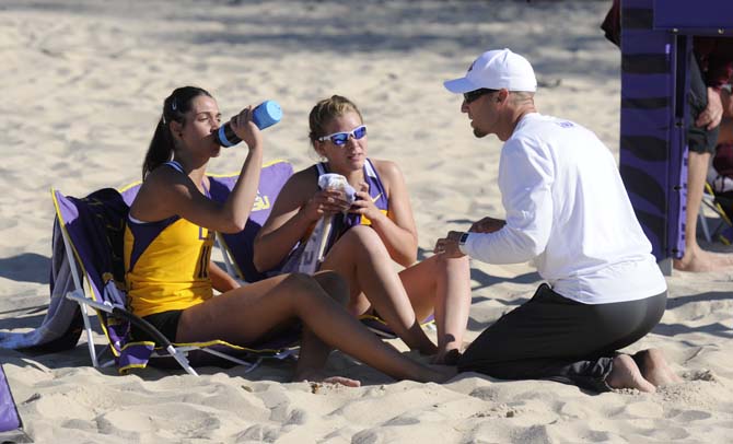 LSU associate head sand volleyball coach Russell Brock talks to freshmen Katarina Raicevic (11) and Emma Hiller (20) between sets Tuesday, March 18, 2014, during the Tigers' 2-3 loss to ULM at Mango's Outdoor Volleyball.