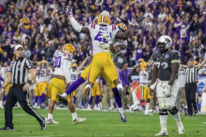 LSU junior linebacker Devin White (40) and sophomore cornerback Patrick Queen (8) celebrate after a play during the Tigers' 40-32 victory over UCF on Tuesday, Jan. 1, 2019, in State Farm Stadium.