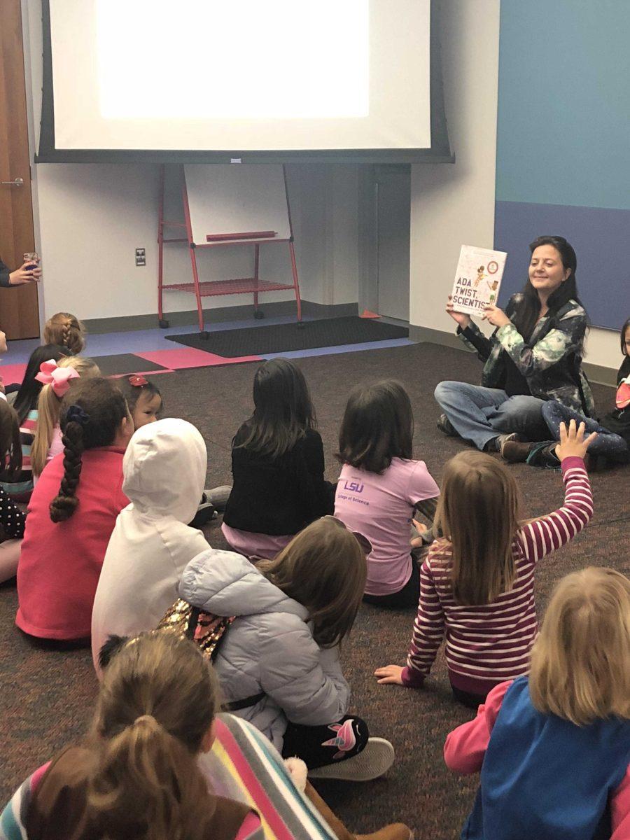 Dr. Tabetha Boyajian reading to young girls during Goodwood Library for Geaux Science for Girls.