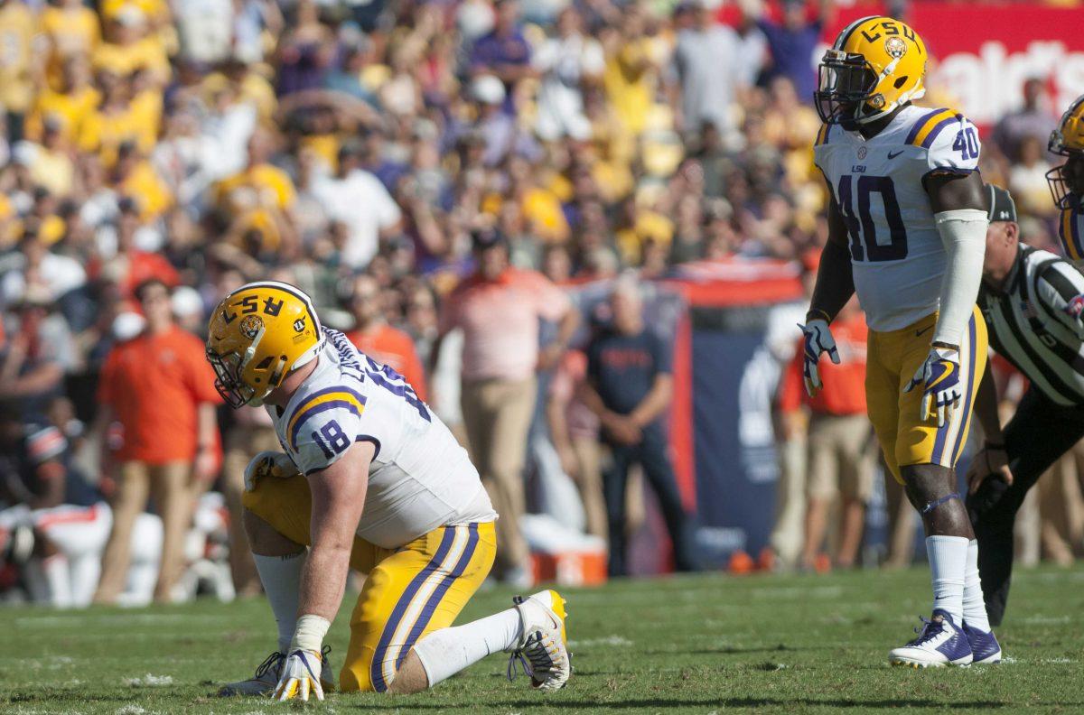 LSU sophomore linebacker Devin White (40) watches LSU senior defensive end Christian LaCouture (18) during the LSU Tigers' 27-23 victory against Auburn on Saturday, Oct. 14, 2017 in Tiger Stadium.