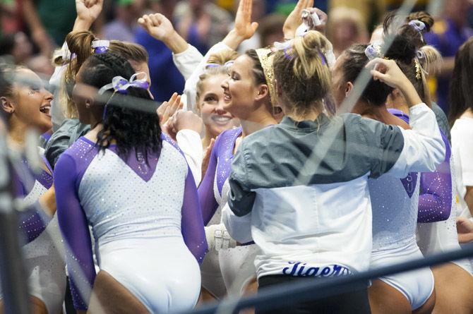 LSU all-around junior Sarah Finnegan cheers celebrates with her team after scoring a 10.00 in the bars competition during the Tigers&#8217; 198.125-195.525 victory over Arizona on Saturday, March 17, 2018, in the PMAC.