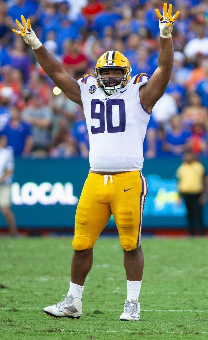 LSU junior defensive end Rashard Lawrence (90) holds up a four for the fourth quarter during the Tigers&#8217; 27-19 loss against the University of Florida on Saturday, Oct. 6, 2018 in Ben Hill Griffin Stadium.