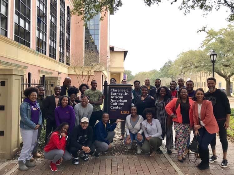 The Black History Month Committee stands outside the Clarence L. Barney, Jr. African American Cultural Center.