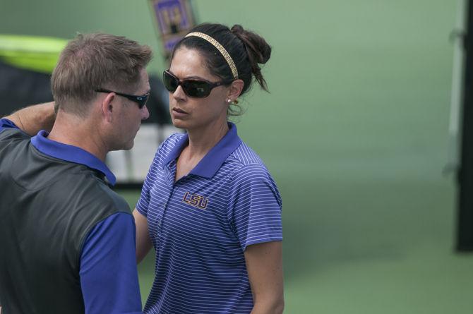 LSU co-head coach Julia Sell converses with co-head coah Michael Sell during the Tigers' 4-3 victory against Kentucky in the SEC Championship on Thursday, April 21, 2016 at the LSU Tennis Complex.