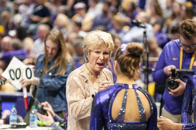 LSU coach D-D Breaux talks with an LSU gymnast during the Tigers' 197.500-197.425 loss to Florida on Friday, Jan. 18, 2019 in the PMAC.