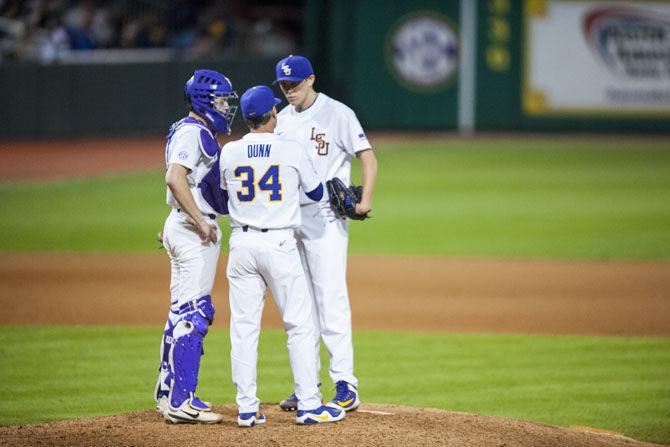 LSU coach Alan Dunn (34) talks to the baseball players during the Tigers&#8217; 8-1 victory against Toledo on Friday, March 2, 2018, at Alex Box Stadium.