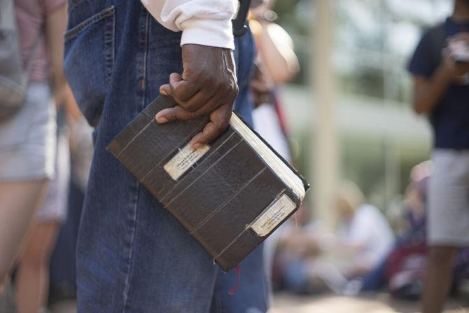 A member of the Consuming Fire Fellowship holds his heavily taped Bible on Sept. 27, 2016, in Free Speech Plaza.