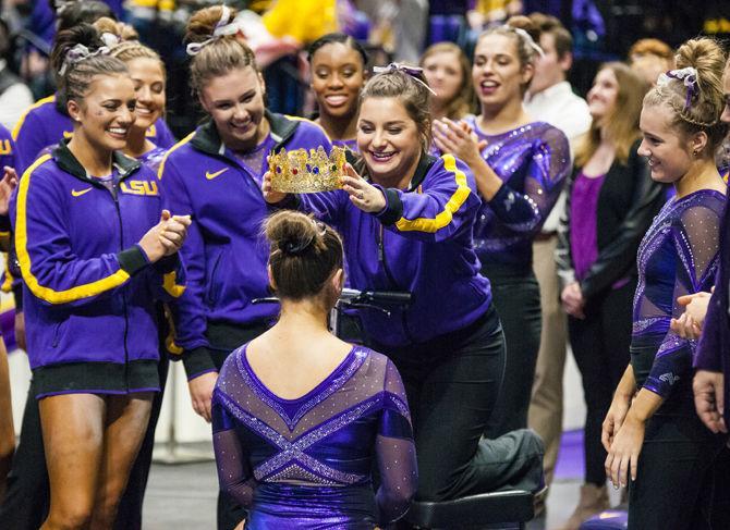 LSU junior McKenna Kelley deems freshman Christina Desiderio "stick queen" during the Tigers' 197.15-195.350 victory against Arkansas on Friday, Jan. 5, 2018, in the PMAC.