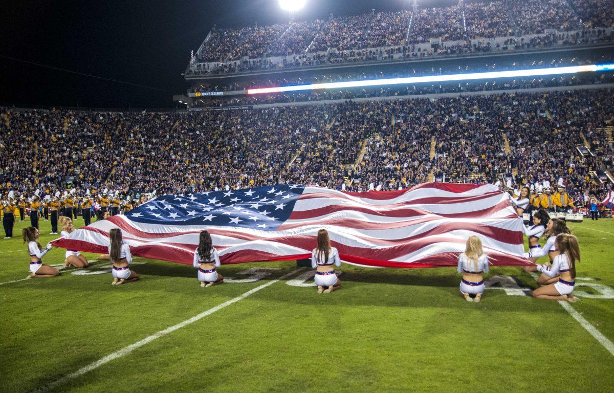 LSU Golden Girls hold the American Flag in the halftime show during the Tigers' 31-14 defeat against The University of Arkansas on Saturday, Nov. 11, 2015 in Tiger Stadium.