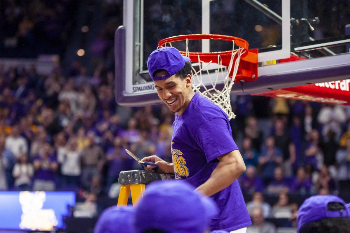 LSU sophomore guard Tremont Waters cuts a piece of the net after the Tigers' 80-59 victory over Vanderbilt on Saturday, March 9, 2019, in the PMAC.