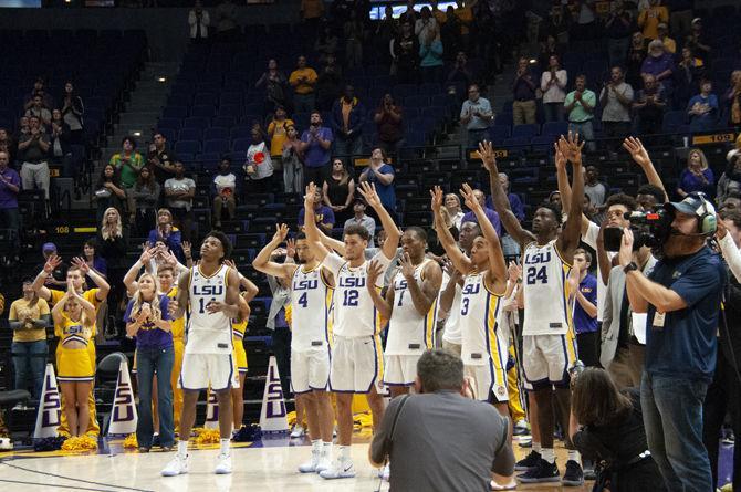 LSU men's basketball hold up fours in honor of Wayde Sims during the Tigers' 94-63 win against Southeatern on Tuesday, Nov. 6, 2018, in the PMAC.