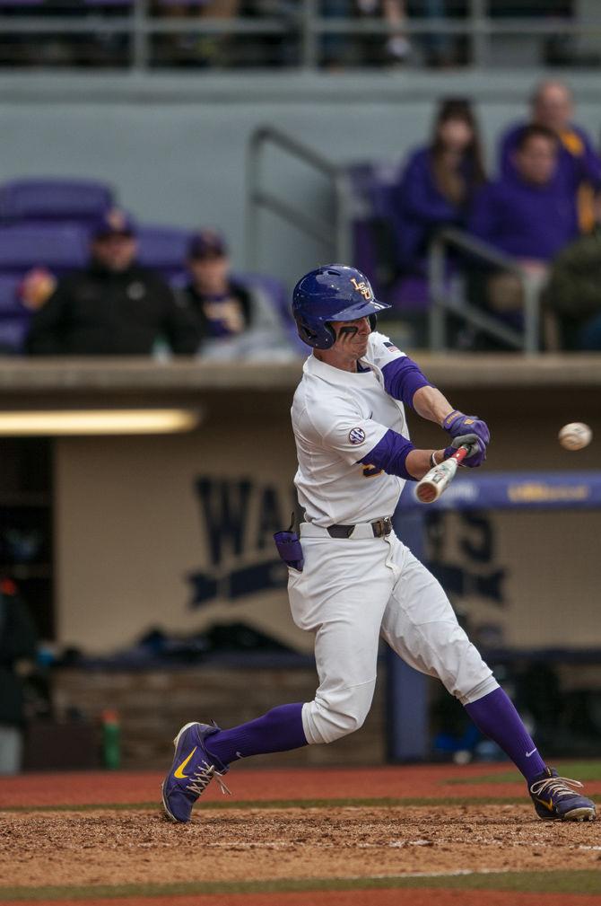 LSU junior center fielder Zach Watson (9) hits the ball during the Tigers' 2-1 victory over Kentucky on Saturday, March 16, 2019, in Alex Box Stadium.