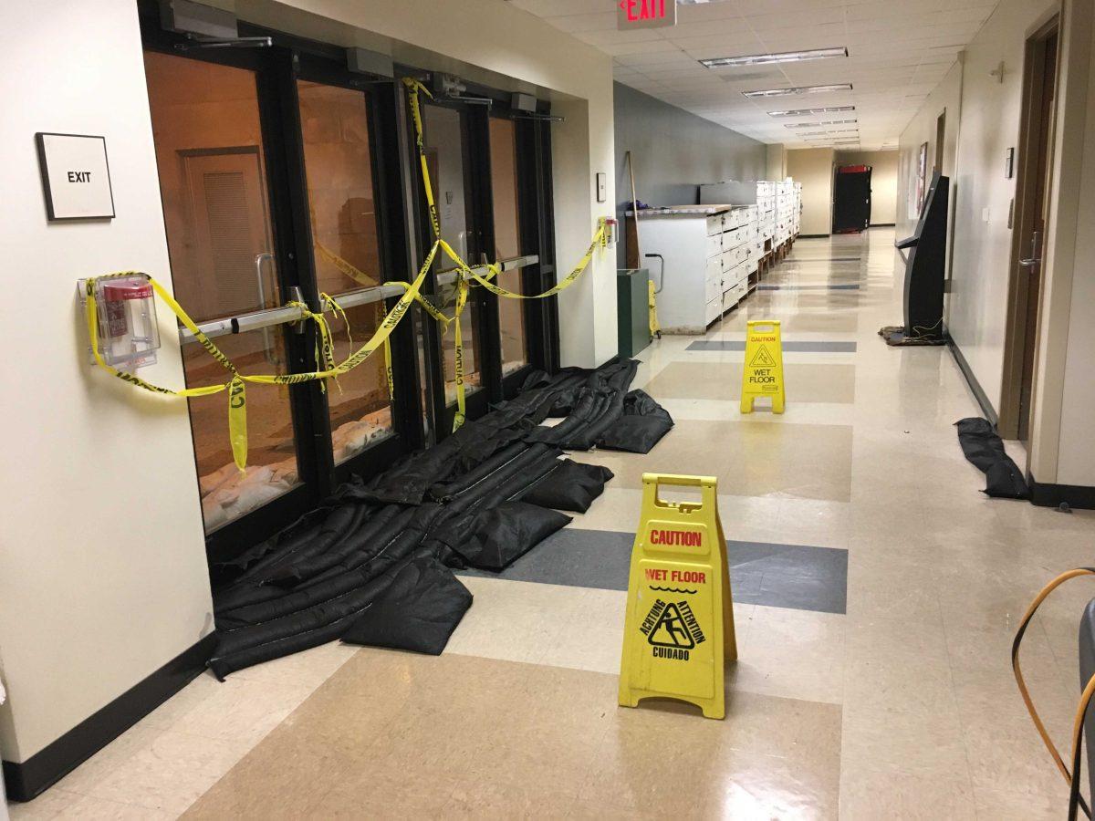 Black sandbags are used to absorb incoming water in the Hatcher Hall basement on April 4, 2019.