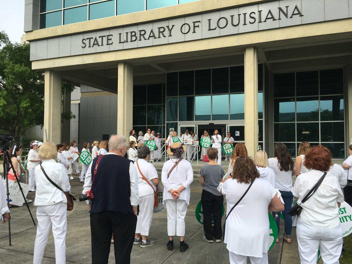 Activists gather at the State Library of Louisiana before marching on April 9.