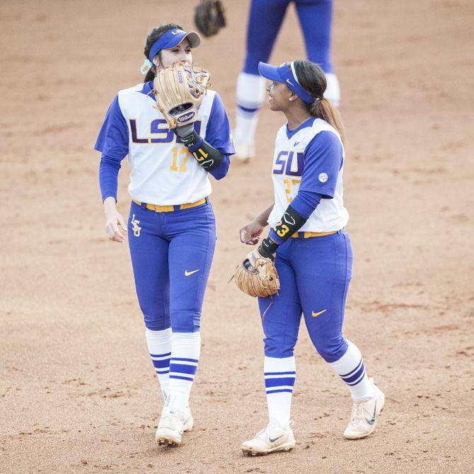 (From left to right) LSU junior infielder Amber Serrett (17) and LSU junior infielder Shemiah Sanchez (23) talk together during LSU&#8217;s 2-0 victory over Texas A&amp;M on Friday, April 20, 2018, at Tiger Park.