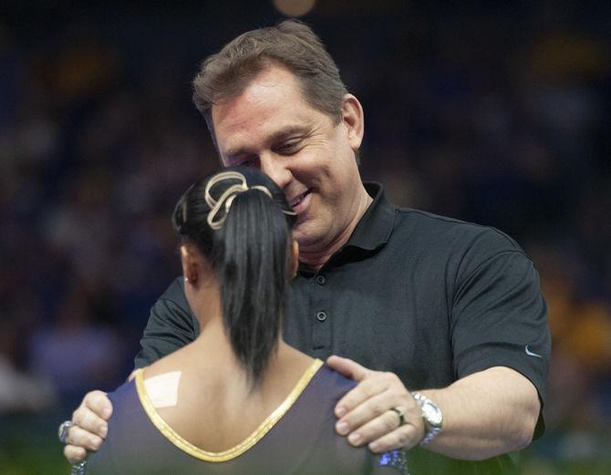 LSU gymnastics coach Jay Clark talks to all-around junior Kennedi Edney during the Tigers' victory in the SEC championship on Saturday, April 6, 2019 in the PMAC.