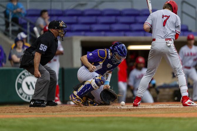 LSU sophomore catcher Saul Garza (13) catches the ball during the Tigers' 5-3 victory over Lamar on Tuesday, April 23, 2019, in Alex Box Stadium.