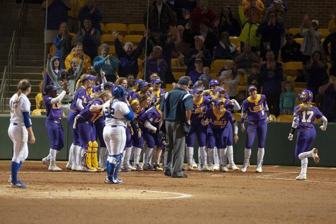 The Lady Tigers celebrate after senior infielder Amber Serrett (17) scored a home run during their 19-1 victory over Tulsa, Thursday, Feb. 7, 2019, in Tiger Park.