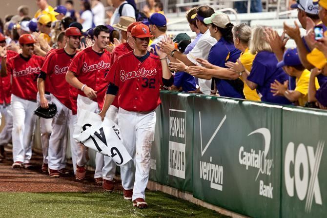 LSU baseball fans line the first base line wall to congratulate and wish Stony Brook University's baseball team good luck June 10, 2012, after the Seawolves defeated the Tigers 7-2 in the NCAA Baton Rouge Super Regionals to advanced to the College World Series.