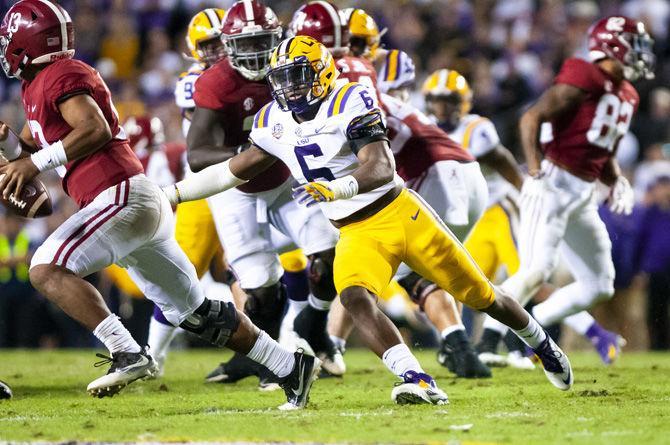 LSU sophomore linebacker Jacob Phillips (6) reaches out to grab an offensive player during the Tigers' 29-0 loss against Alabama on Saturday, Nov. 3, 2018, in Tiger Stadium.