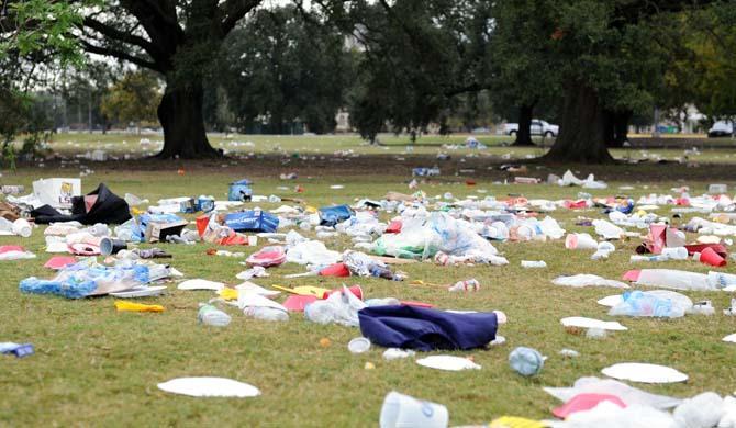 Trash litters the grass beside Nicholson Drive the morning after gameday.