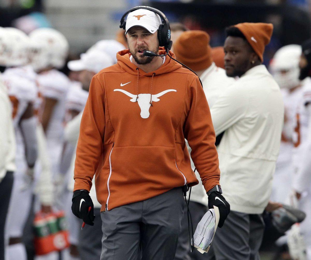 In this Nov. 23, 2018, file photo, Texas head coach Tom Herman works the sideline during the first half of an NCAA college football game against Kansas, in Lawrence, Kan. Herman and LSU head coach Ed Orgeron like the colors they&#8217;ll be wearing Saturday night when No. 6 Tigers meet No. 9 Texas in one of the top non-conference matchups of the 2019 season. (AP Photo/Orlin Wagner)