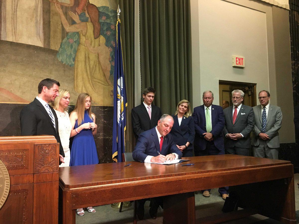 Gov. John Bel Edwards signs the Max Gruver Act among other anti-hazing legislation alongside the Gruver family on Thursday, May 31, 2018 at the Louisiana State Capitol.&#160;