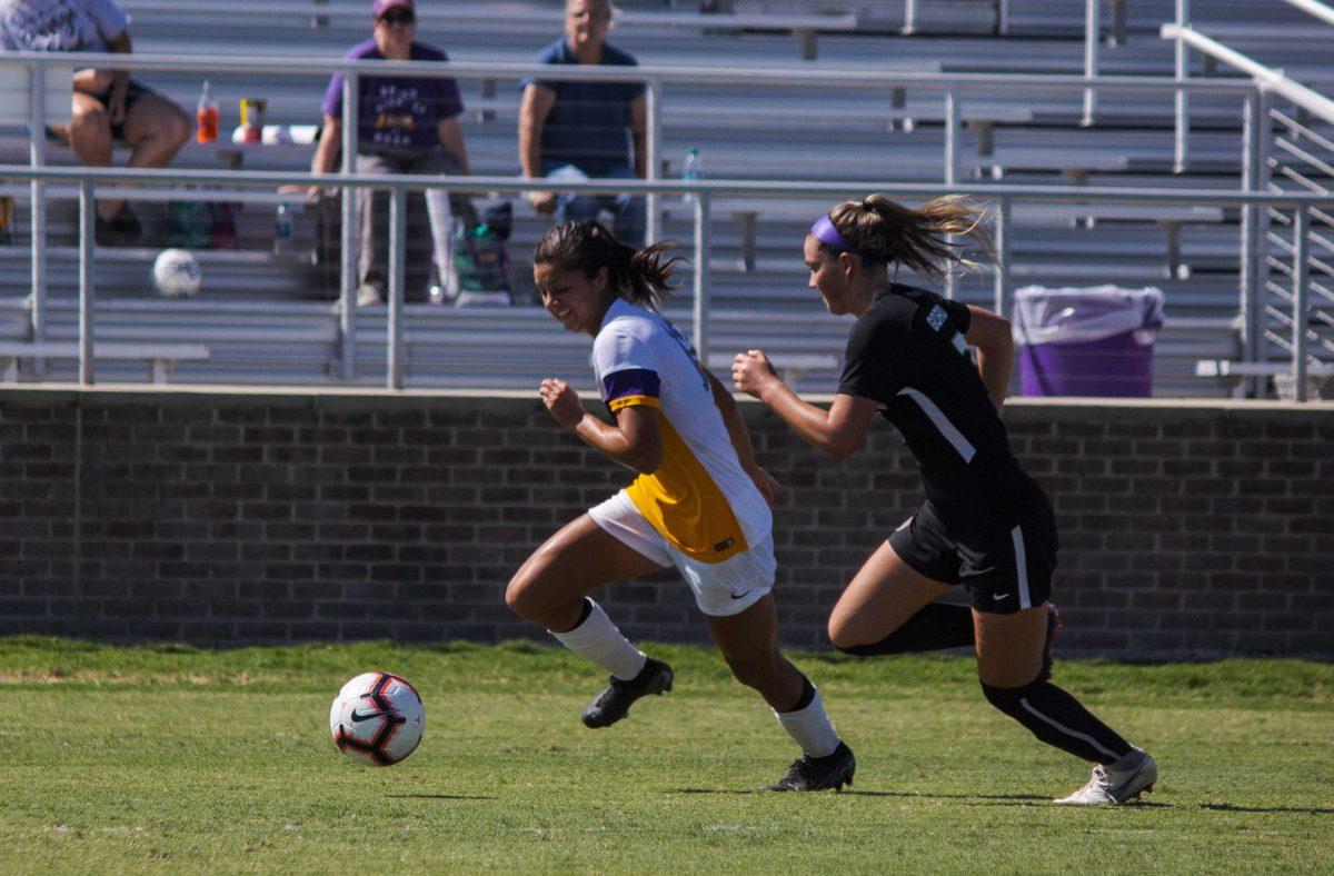 LSU sophomore forward Molly Thompson (12) and JMU sophomore defender Sarah Gordon (7) sprint for the ball on Sunday, Sept. 22, 2019, during the Tigers' 0-1 loss against JMU at the LSU Soccer Complex.