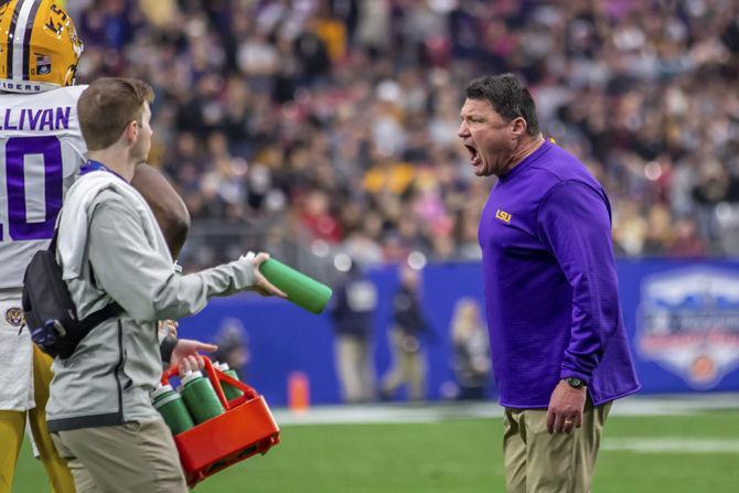 LSU coach Ed Orgeron encourages the team during the Tigers' 40-32 victory over UCF on Tuesday, Jan. 1, 2019, in State Farm Stadium.