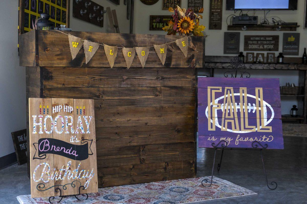 A welcome stand displays in the front of the Board &amp; Brush studio on Wednesday, Sept. 11, 2019, at Board &amp; Brush Creative Studio.