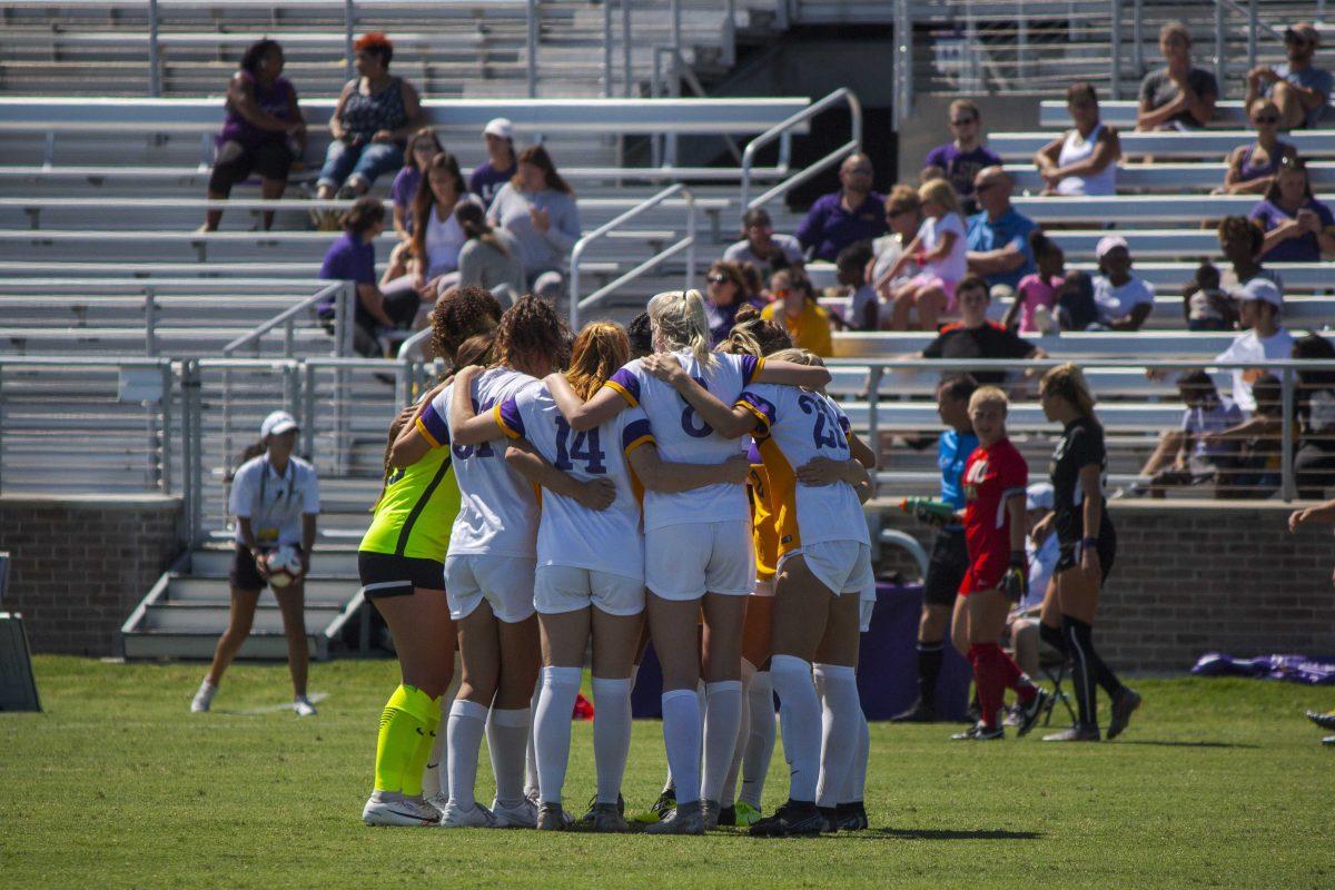 The LSU Tiger Women's Soccer team huddles together before the second half on Sunday, Sept. 22, 2019, during the Tigers' 0-1 loss against JMU at the LSU Soccer Complex.