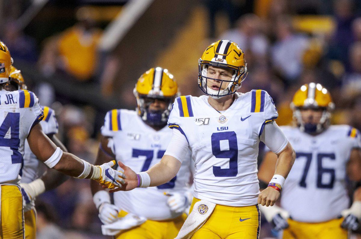 LSU senior quarterback Joe Burrow (9) high fives another player on Saturday, Oct. 12, 2019, during the Tigers' 42-28 victory against the Gators in Tiger Stadium.