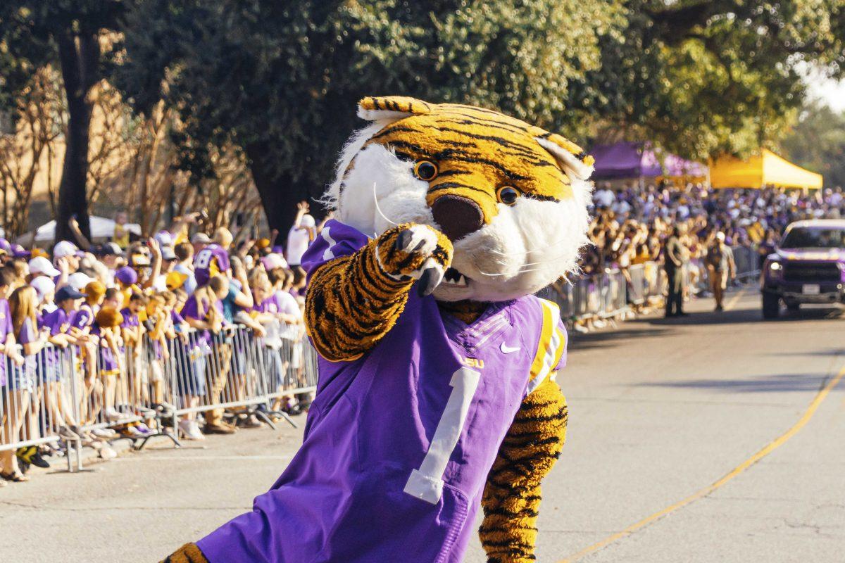 Mike the Tiger interacts with fans as he walks down Victory Hill before LSU's 42-6 win against Utah State on Saturday, October 5, 2019.