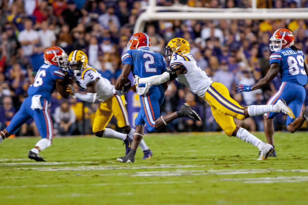 LSU junior safety JaCoby Stevens (3) tackles Florida senior running back Lamical Perine (2) on Saturday, Oct. 12, 2019, during the Tigers' 42-28 victory against the Gators in Tiger Stadium.