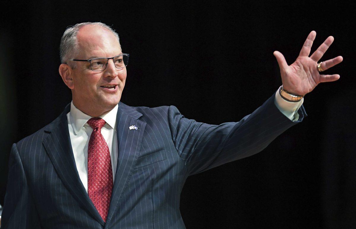 FILE - In this Sept. 19, 2019, file photo, Gov. John Bel Edwards acknowledges his supporters as he comes out onstage for a debate with Eddie Rispone and Republican Rep. Ralph Abraham in Baton Rouge, La. Edwards is battling to hold onto the Democrats&#8217; only governorship in the Deep South. (Bill Feig/The Advocate via AP, Pool, File)