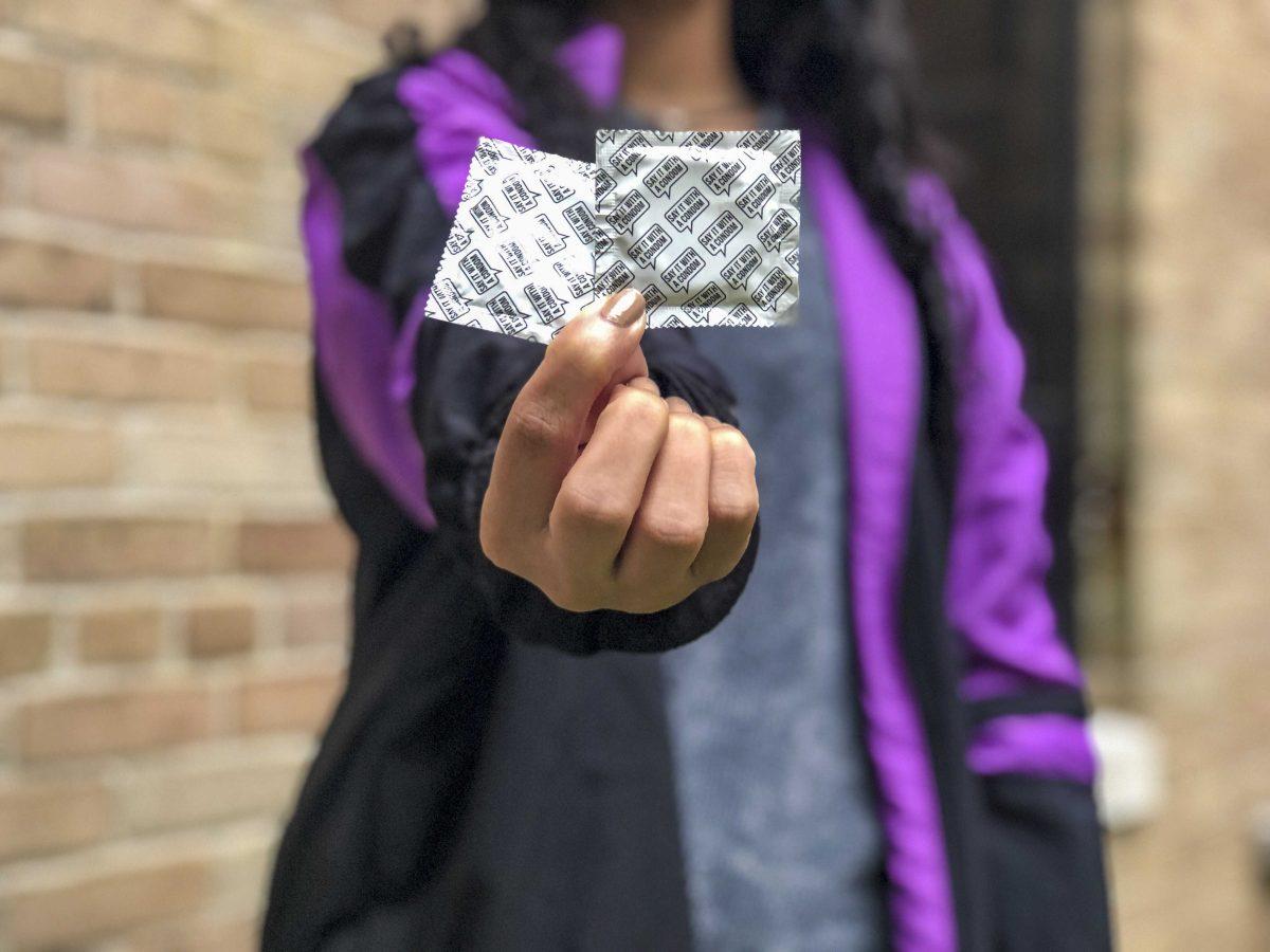 A student holds a condom outside of Hodges Hall on Sunday, Oct. 27, 2019.